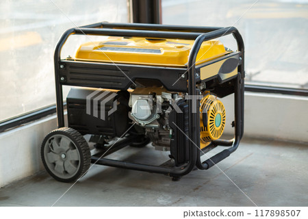 Portable electric generator running in the cold winter.Energy genocide. Small business use gasoline generators 117898507