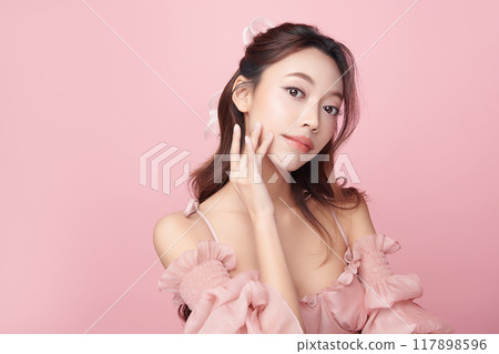 Beautiful young asian woman with clean fresh skin on pink background, Face care, Facial treatment, Cosmetology, beauty and spa, Asian women portrait. Beautiful young asian woman with clean fresh skin on pink background, Face care, Facial treatment, Cosmetology, beauty and spa, Asian women portrait. 117898596