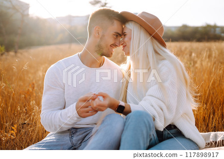Young couple having fun walking and hugging n the park. Autumn weather. Relaxation, youth. 117898917