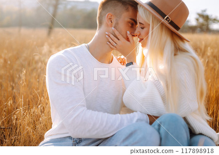 Young couple having fun walking and hugging n the park. Autumn weather. Relaxation, youth. 117898918