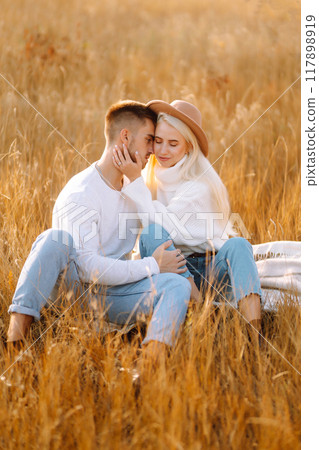 Young couple having fun walking and hugging n the park. Autumn weather. Relaxation, youth. 117898919