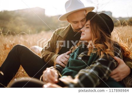 Lovely hipster couple enjoying each other in the autumn park. Nice autumn day. love and lifestyle. 117898984