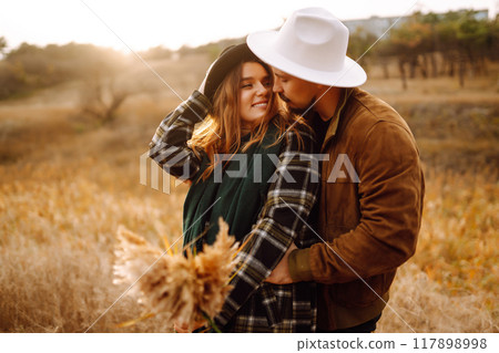 Lovely hipster couple resting in nature. People, lifestyle, relaxation and vacations concept. Lovely hipster couple resting in nature. People, lifestyle, relaxation and vacations concept. 117898998