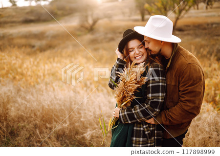 Lovely hipster couple enjoying each other in the autumn park. Nice autumn day. love and lifestyle. Lovely hipster couple enjoying each other in the autumn park. Nice autumn day. love and lifestyle. 117898999