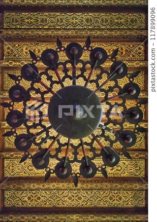 Bottom view of chandelier in Mezquita Catedral, Cordoba. View from below of lamp in mosque. Forged metal lustre in interior Great Mosque. 117899096