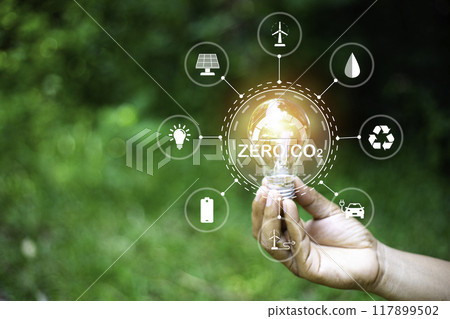 green energy concept help reduce global warming..Hand holding natural background light bulb on green leaf with clean energy icon around it. Carbon dioxide emission in industry zero carbon concept.. 117899502
