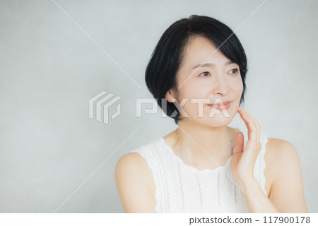 Middle-aged woman doing skin care Middle-aged woman doing skin care 117900178