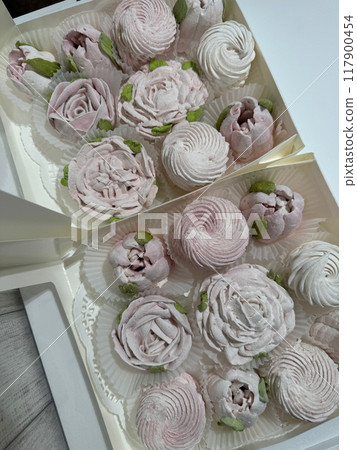Homemade marshmallows in open boxes. Marshmallow flowers and classic marshmallows. View from above. Homemade marshmallows in open boxes. Marshmallow flowers and classic marshmallows. View from above. 117900454
