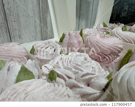 Homemade marshmallows in open boxes. Marshmallow flowers and classic marshmallows. Close up. 117900457