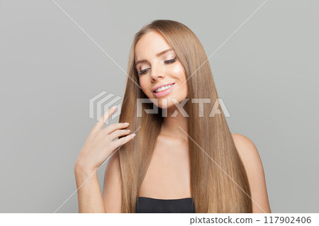 Happy model. Woman with long brown hair, natural makeup and healthy clean skin 117902406