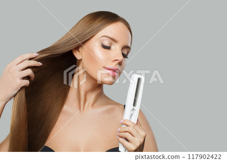 Cheerful fashion model with brown shiny straight haistyle portrait. Cute woman Cheerful fashion model with brown shiny straight haistyle portrait. Cute woman 117902422