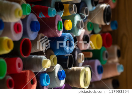 Spools of multi-colored threads. Spools of multi-colored threads. 117903394