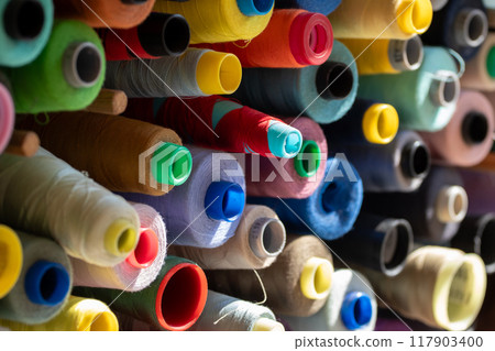 Spools of multi-colored threads. 117903400