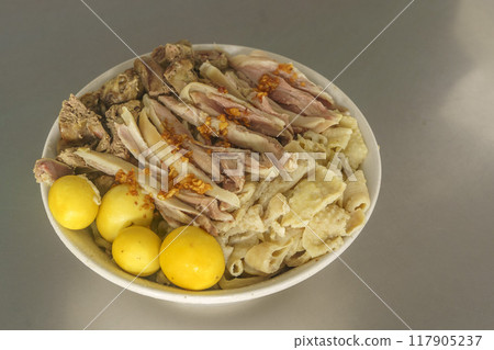 A bowl of Mie Ayam with various toppings. 117905237