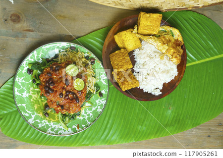 A vibrant plate of Plecing Kangkung, Lombok, Indonesian traditional food. A vibrant plate of Plecing Kangkung, Lombok, Indonesian traditional food. 117905261