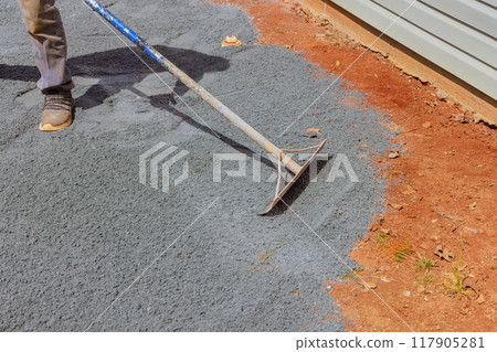 Ground is leveled, filled with fine gravel stones for pouring concrete into foundation of house, construction work 117905281