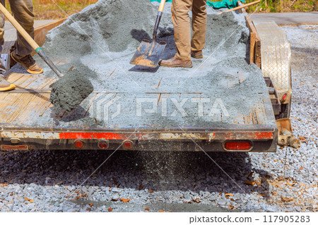 During leveling of driveway, workers filled parking lot near house with small stones 117905283