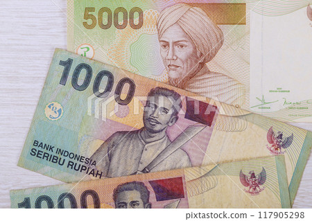 Paper money in form of Indonesian rupiah with varying denominations Paper money in form of Indonesian rupiah with varying denominations 117905298