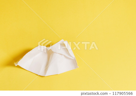 Remains of a plastic glass on a yellow background. Remains of a plastic glass on a yellow background. 117905566