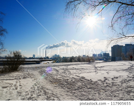 View of a city park against the backdrop of a smoking chimney. View of a city park against the backdrop of a smoking chimney. 117905655