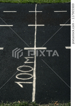 A rubber treadmill at the stadium. White markings on the stadium track 117905989