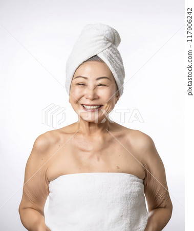 Image of a woman in her 70s feeling the moisture in her skin 117906242