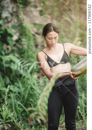 Young woman in nature with a surfboard 117906582