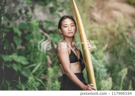 Young woman in nature with a surfboard Young woman in nature with a surfboard 117906584