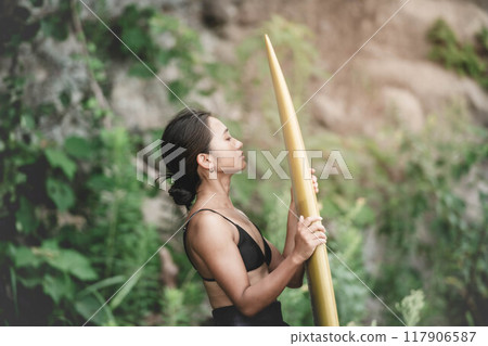Young woman in nature with a surfboard Young woman in nature with a surfboard 117906587