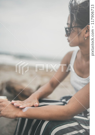 Young woman doing skin care at the beach 117906713
