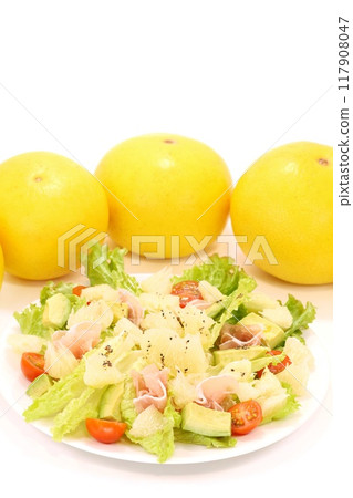 Tosa Buntan, prosciutto and avocado salad. Large citrus fruits. Light background. 117908047