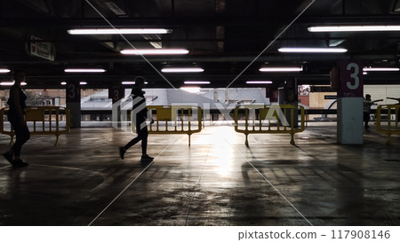 people walk through the closed parking. people walk through the closed parking. 117908146