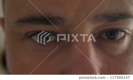 close-up of a young man opening his eyes and blinking close-up of a young man opening his eyes and blinking 117908147
