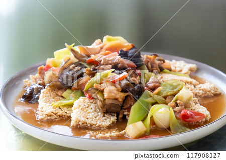Simple and authentic Sichuan cuisine of mixed stir fry of celtuce with pork slice, black fungus, chili pepper and rice cracker Simple and authentic Sichuan cuisine of mixed stir fry of celtuce with pork slice, black fungus, chili pepper and rice cracker 117908327