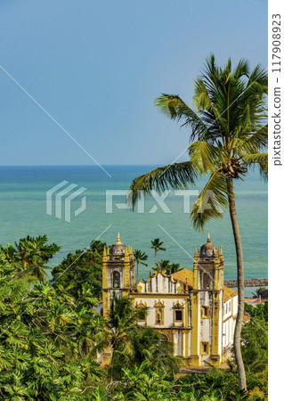 Church between vegetation and the sea 117908923
