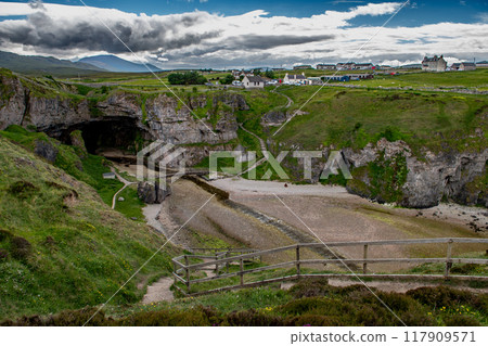 Entrance With Bridge To Smoo Cave, Hideout Of Bonnie Prince Charles, At The Atlantic Coast Of Village Durness In Scotland, UK Entrance With Bridge To Smoo Cave, Hideout Of Bonnie Prince Charles, At The Atlantic Coast Of Village Durness In Scotland, UK 117909571
