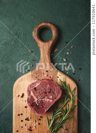 fresh, raw rib eye steak, on a chopping board, top view, no people, fresh, raw rib eye steak, on a chopping board, top view, no people, 117910641