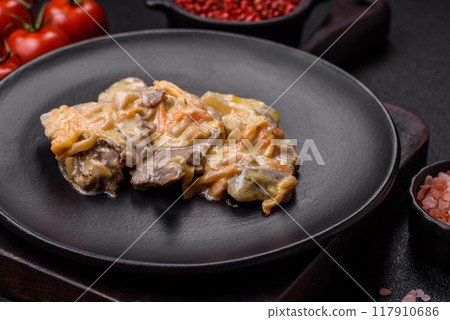 Delicious boiled beef or pork tongue sliced with carrots, onions, sour cream 117910686