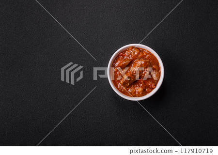 Thai Asian dish with meat, hot pepper, tomato sauce and sesame 117910719