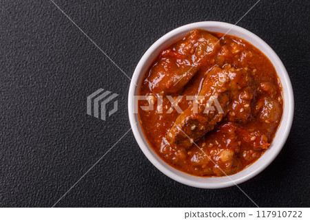 Thai Asian dish with meat, hot pepper, tomato sauce and sesame Thai Asian dish with meat, hot pepper, tomato sauce and sesame 117910722