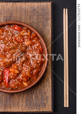 Thai Asian dish with meat, hot pepper, tomato sauce and sesame 117910754