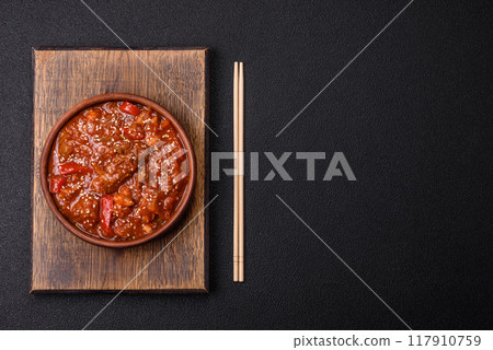 Thai Asian dish with meat, hot pepper, tomato sauce and sesame 117910759