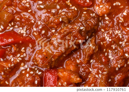 Thai Asian dish with meat, hot pepper, tomato sauce and sesame 117910761