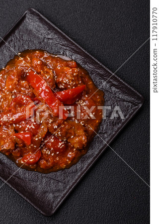 Thai Asian dish with meat, hot pepper, tomato sauce and sesame 117910770
