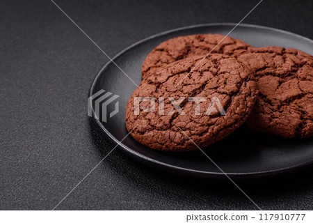 Delicious crispy round oatmeal cookies with chocolate 117910777