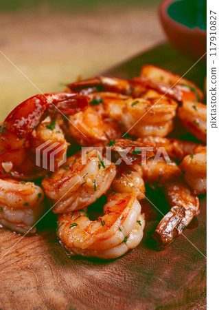 fried tiger prawns, jumbo, in garlic sauce, in butter, with herbs, on a wooden board, homemade, no people, fried tiger prawns, jumbo, in garlic sauce, in butter, with herbs, on a wooden board, homemade, no people, 117910827