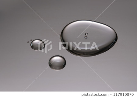 A smear of cosmetic gel close-up on a gray background. A smear of cosmetic gel close-up on a gray background. 117910870