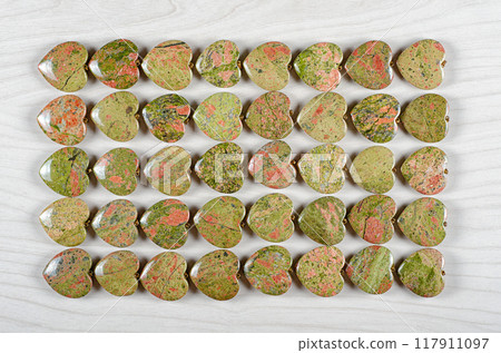 Healing Hearts of Unakite: Captivating Arrangement of Green and Pink Gemstones Attracts Spiritual Seekers and Jewelry Makers. 117911097