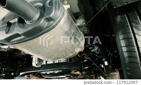 Under car exhaust pipe and suspension. Automotive mufflers. Inspection of car for Defects. Metal fittings and pipes for the muffler. Suspension elements and exhaust system. Auto parts and car service Under car exhaust pipe and suspension. Automotive mufflers. Inspection of car for Defects. Metal fittings and pipes for the muffler. Suspension elements and exhaust system. Auto parts and car service 117912007