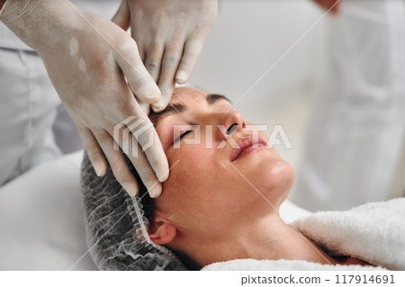 Relaxation during a facial treatment at a spa in a serene environment Relaxation during a facial treatment at a spa in a serene environment 117914691